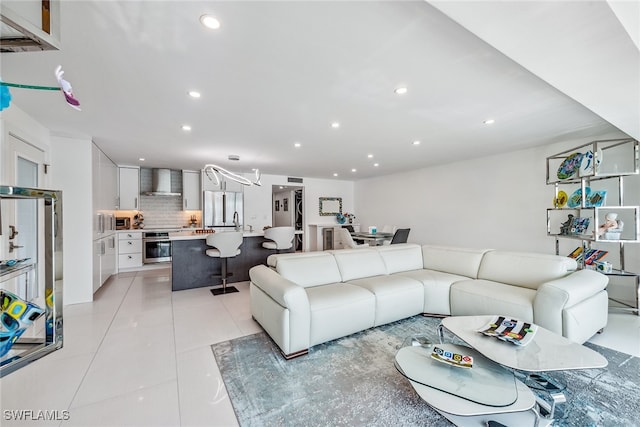 living room featuring light tile patterned flooring and sink