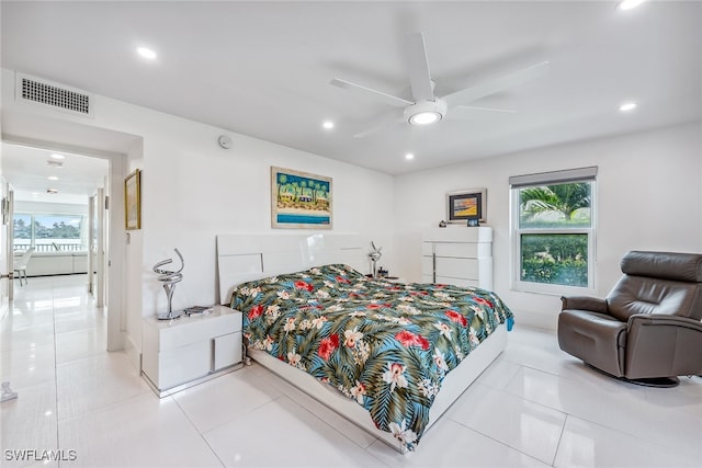 bedroom with ceiling fan and light tile patterned floors