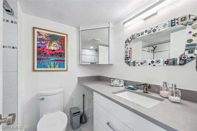 bathroom featuring vanity and toilet