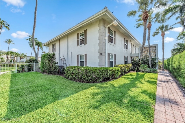 view of side of property with a lawn