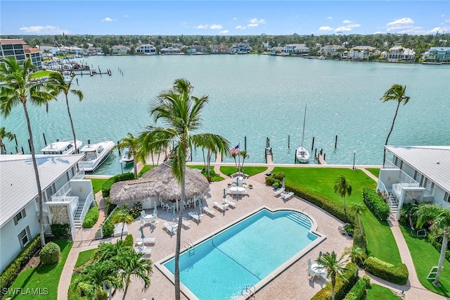 exterior space featuring a patio, a water view, and a yard