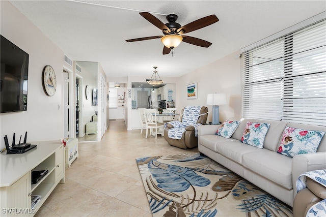 tiled living room with ceiling fan