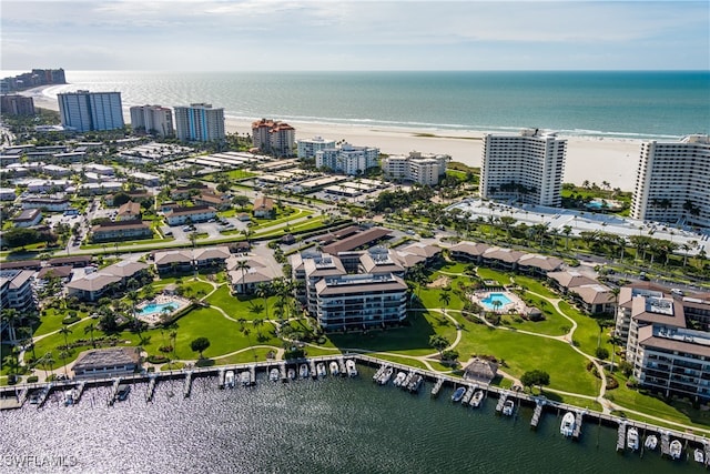 birds eye view of property with a view of the beach and a water view