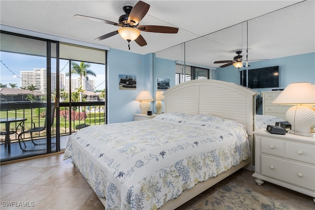 tiled bedroom featuring ceiling fan, expansive windows, and access to outside