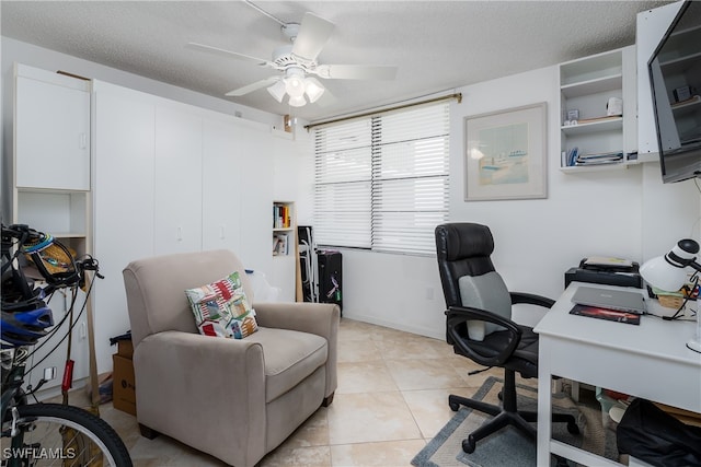 tiled home office featuring ceiling fan and a textured ceiling