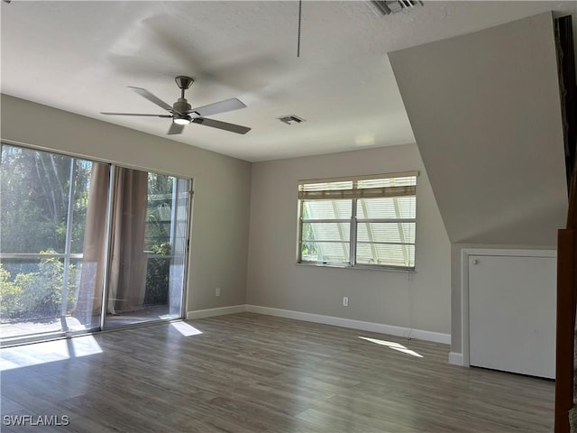 unfurnished room with hardwood / wood-style flooring, a wealth of natural light, and ceiling fan