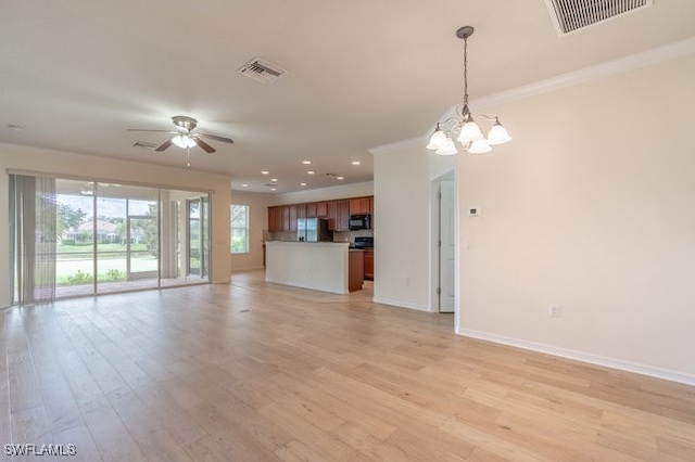 unfurnished living room with ceiling fan with notable chandelier and light wood-type flooring