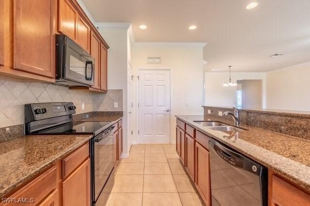 kitchen featuring sink, black appliances, light tile patterned floors, crown molding, and light stone countertops