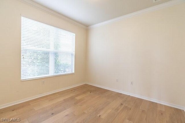 unfurnished room with ornamental molding and light hardwood / wood-style flooring