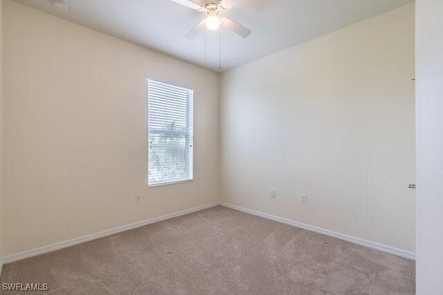 carpeted empty room featuring ceiling fan