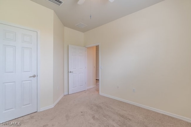 unfurnished bedroom with ceiling fan and light carpet