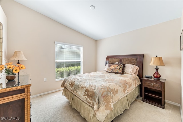 bedroom featuring vaulted ceiling and light colored carpet