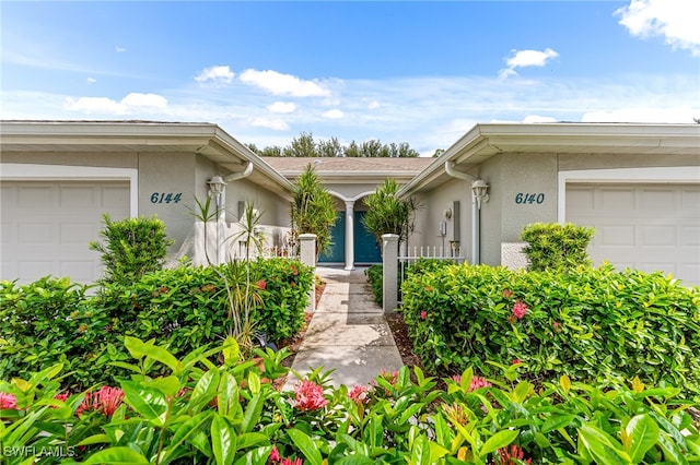 view of exterior entry featuring a garage