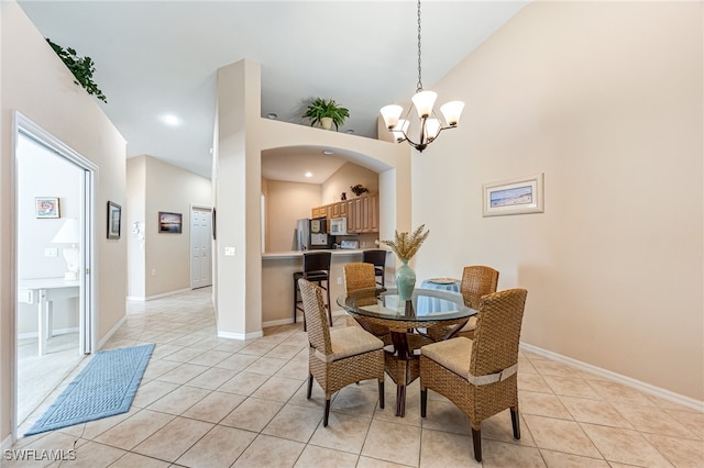 tiled dining space with a notable chandelier and high vaulted ceiling