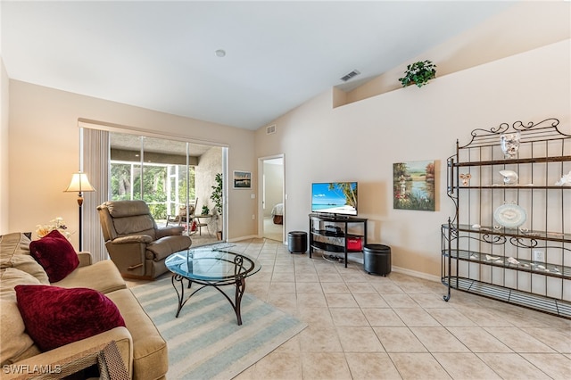 living room with light tile patterned flooring and vaulted ceiling