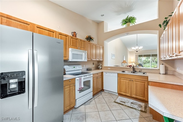 kitchen with hanging light fixtures, light tile patterned floors, sink, white appliances, and a chandelier