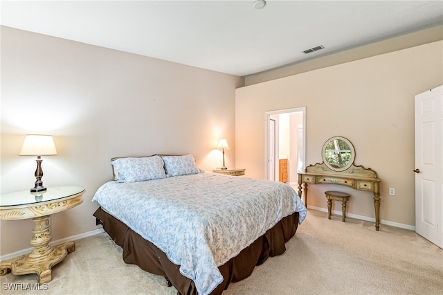 carpeted bedroom featuring ensuite bathroom