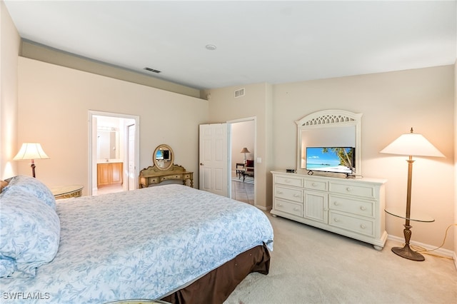 carpeted bedroom featuring ensuite bathroom