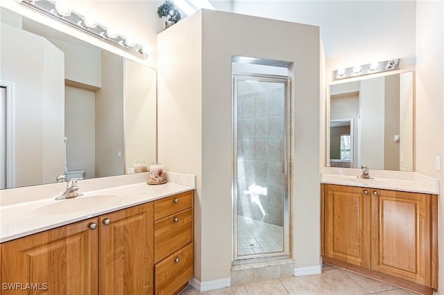 bathroom with vanity, toilet, tile patterned floors, and an enclosed shower