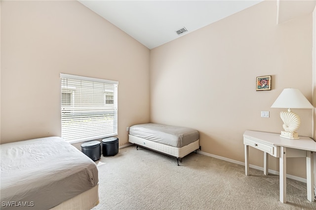 carpeted bedroom featuring high vaulted ceiling