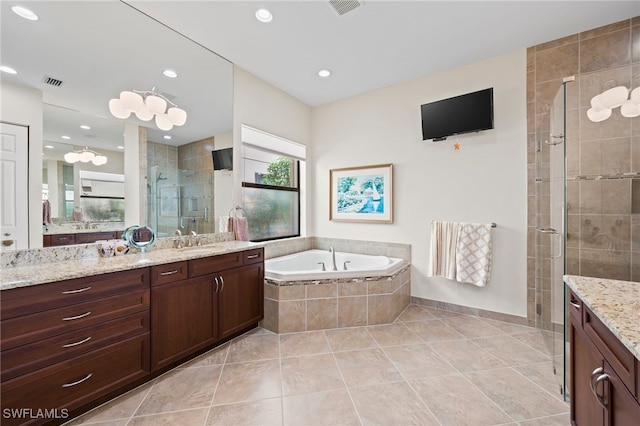 bathroom with independent shower and bath, vanity, and tile patterned floors