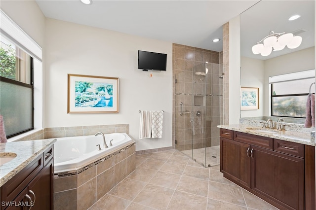 bathroom with shower with separate bathtub, tile patterned flooring, and vanity