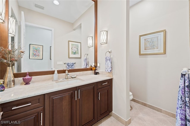 bathroom featuring vanity, toilet, and tile patterned floors