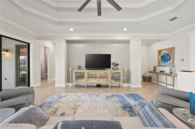 tiled living room featuring a tray ceiling, ceiling fan, and crown molding