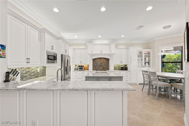 kitchen featuring light tile patterned flooring, white cabinetry, kitchen peninsula, decorative backsplash, and stainless steel appliances