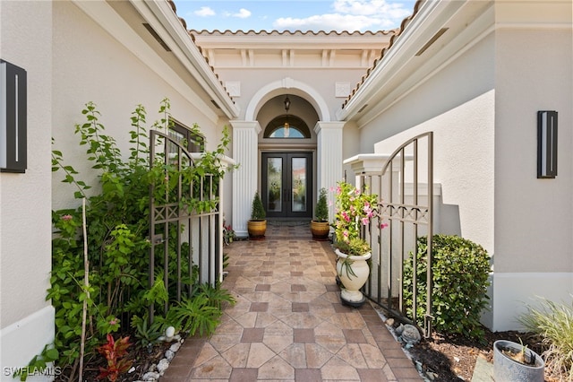 view of exterior entry featuring french doors