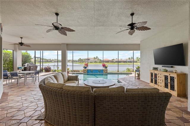 interior space featuring ceiling fan and outdoor lounge area