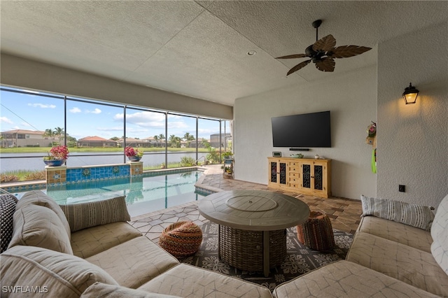 living room featuring ceiling fan and a textured ceiling