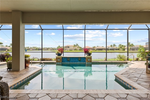 view of pool featuring a water view, a patio, and a lanai