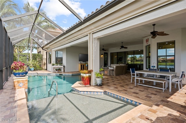 view of pool featuring ceiling fan, a lanai, and a patio area