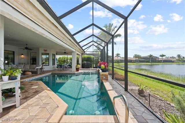 view of swimming pool with glass enclosure, a water view, ceiling fan, and a patio