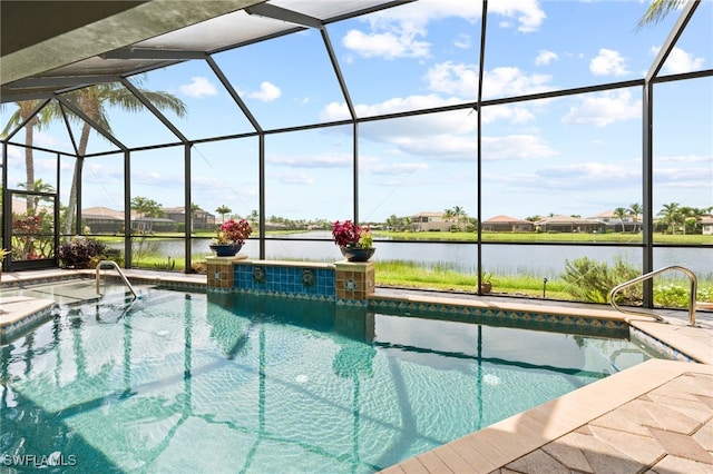 view of pool with glass enclosure, a water view, and a patio area