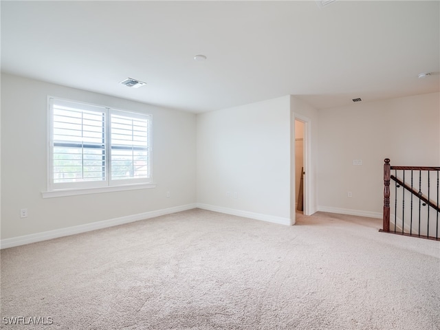 spare room with light colored carpet