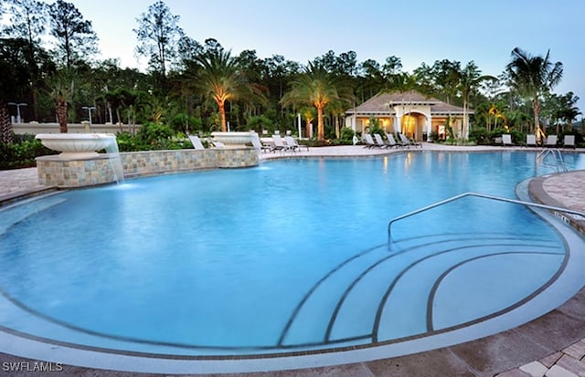 view of pool with a patio, a gazebo, and pool water feature