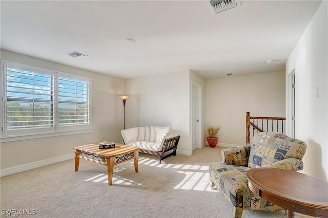 sitting room featuring light colored carpet