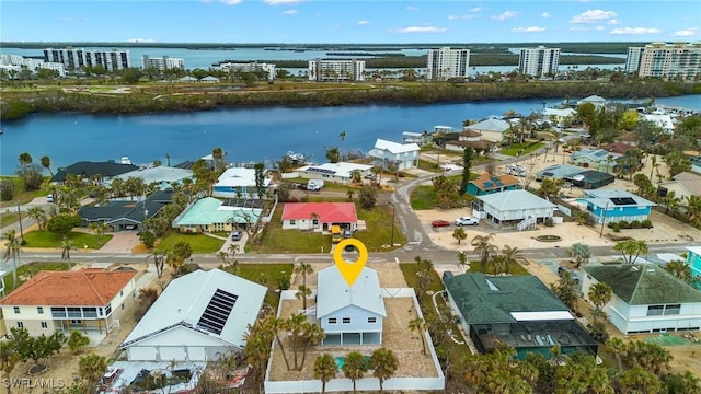 birds eye view of property featuring a view of city and a water view