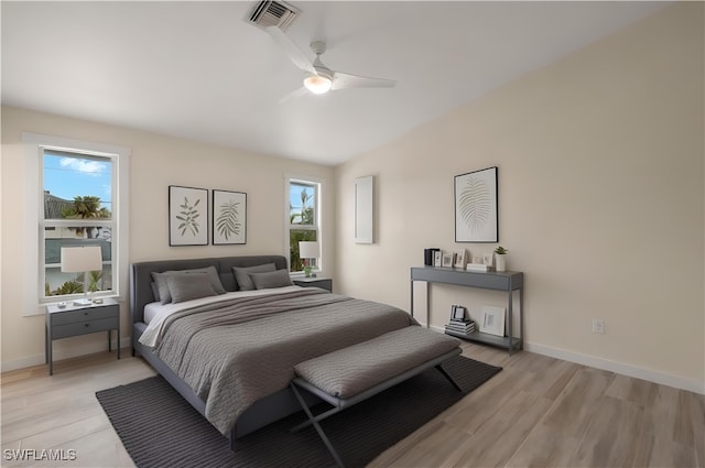 bedroom featuring baseboards, ceiling fan, visible vents, and light wood-style floors