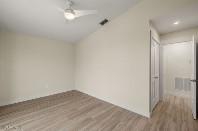 empty room with visible vents, light wood-style flooring, and baseboards