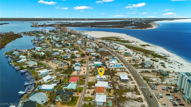 bird's eye view with a water view and a view of the beach