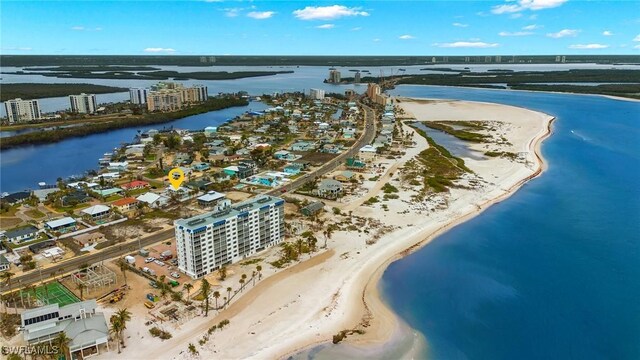 drone / aerial view with a water view and a beach view