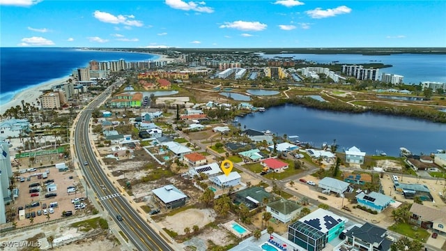 birds eye view of property with a view of city and a water view