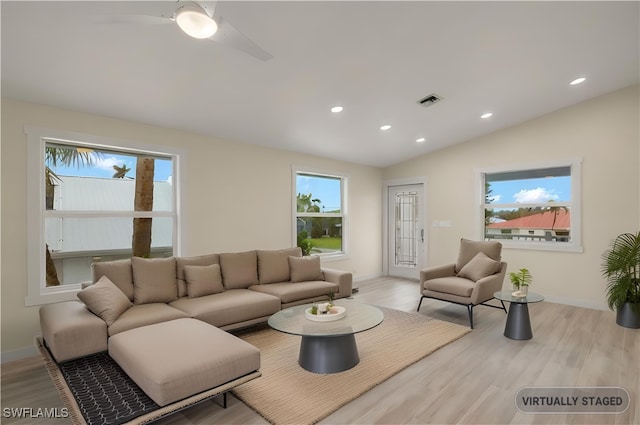 living room with recessed lighting, visible vents, vaulted ceiling, and wood finished floors