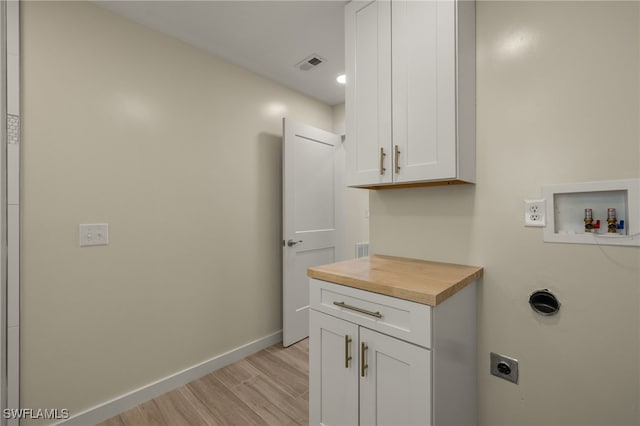 laundry area featuring washer hookup, visible vents, baseboards, cabinet space, and electric dryer hookup