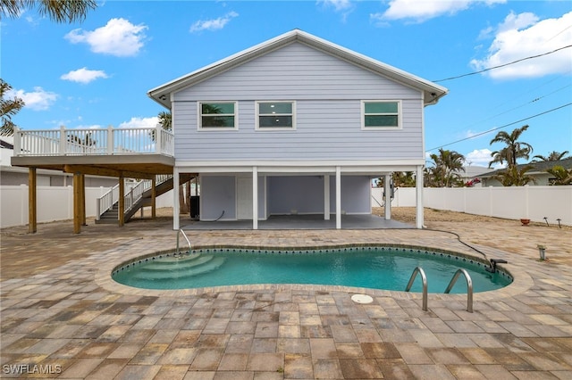 rear view of property featuring a fenced backyard, a patio, a deck, and stairs