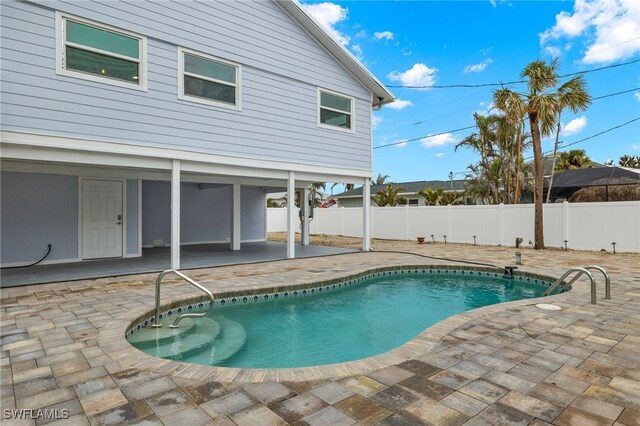 view of swimming pool with a patio area