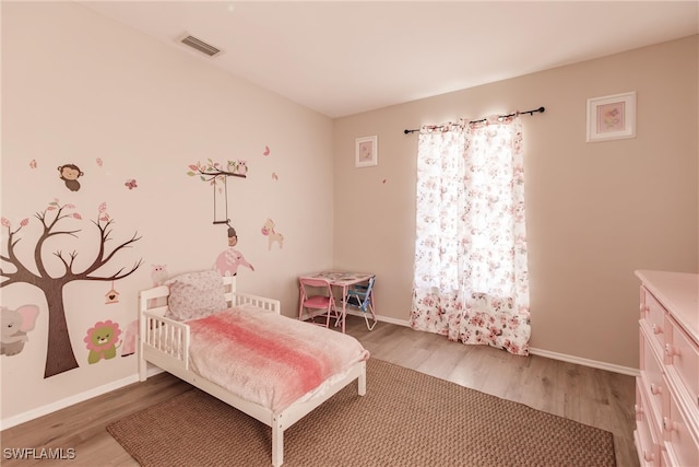 bedroom with hardwood / wood-style flooring